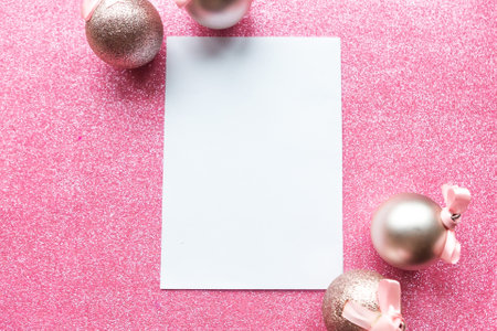 White mockup blank and baubles on pink background. Christmas greeting cardの写真素材