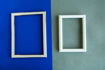 Two photo frames on geometric blue and gray background, copy space for the text, template for designerの写真素材