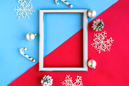 Photo frame and Christmas decorations on color background. Copy space for the text. Template for...