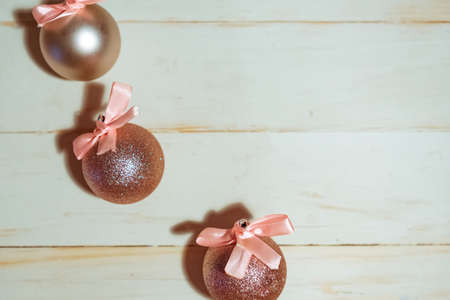 Christmas baubles with bows on wooden background, copy space for the textの写真素材