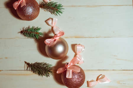 Christmas baubles with bows on wooden background, copy space for the textの写真素材