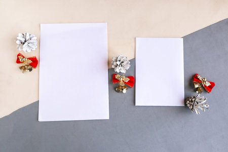 Two mockup blanks and Christmas decoration on color background. Template for Christmas greeting card