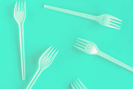 Plastic forks on blue background, top viewの写真素材