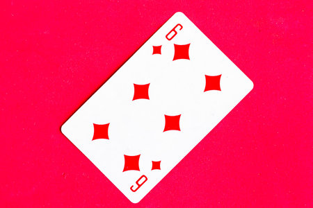 Six of Diamonds playing card, red background.
