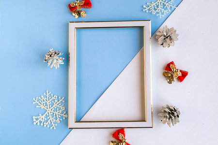 Photo frame and Christmas decorations on color geometric background, copy space for the text....