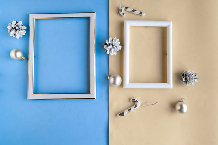 Two photo frames and Christmas decoration on color geometric background. Copy space for the text....