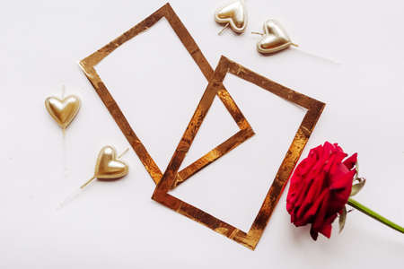 Golden frame and red rose on white background. Template for Valentines Day greeting cardの写真素材