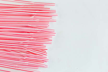 Plastic drinking cocktail straws on white background, top view. Make a cocktail.の写真素材