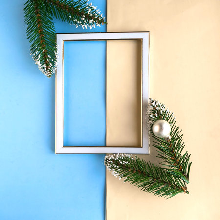 Photo frame and Christmas decorations on color geometric background, copy space for the text....
