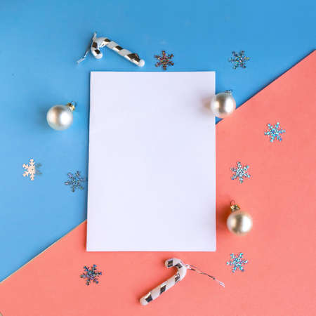 White mockup blank and Christmas decorations on color background. Copy space for the text. Template for Christmas greeting card. Merry Christmas and Happy New Yearの写真素材