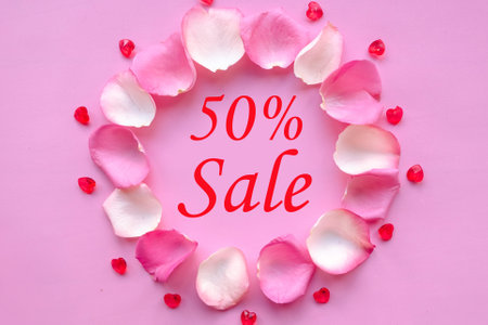 Valentines Day sale concept with rose petals at pink background, top viewの写真素材