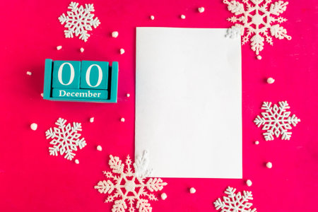 December 0. Blue cube calendar with month and date and white mockup blank, top view, red backgroundの写真素材