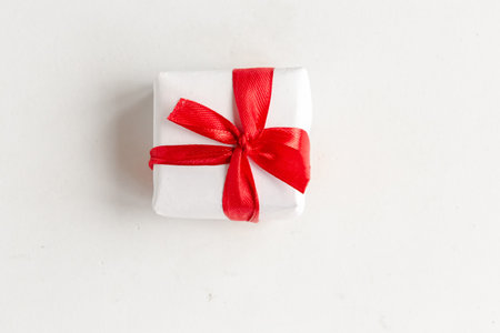 Gift box with red bow on white background, top viewの写真素材