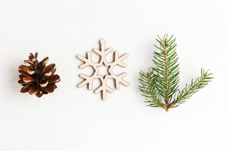 Christmas composition with toy snowflake, pinecone and fir branch on white background, top view, minimal conceptの写真素材