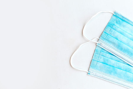 Two medical masks on white background, copy space