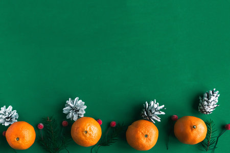 Tangerine pattern on green background. Christmas festive background. Copy space for the textの写真素材