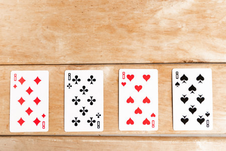 Poker quads playing card, wooden backgroundの写真素材