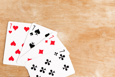 Poker quads playing card, wooden backgroundの写真素材