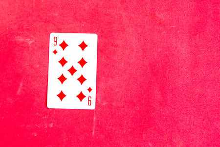 Nine of Diamonds playing card, red background, copy spaceの写真素材