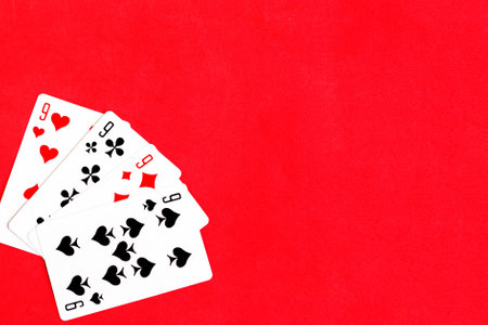 Poker quads playing card, red background, copy spaceの写真素材