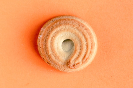Sweet tasty homemade biscuit isolated on orange background, top viewの写真素材