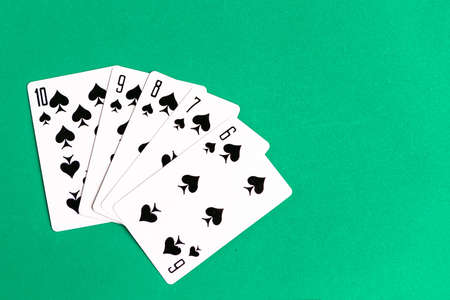 Poker straight flush playing card, top view, copy space, green backgroundの写真素材