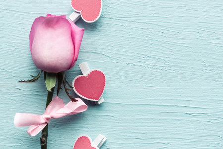 Rose and hearts on wooden background. Valentine's Day background. Copy space for the textの写真素材