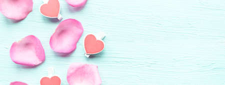 Rose petals on wooden background. Valentine's Day background. Copy space for the textの写真素材