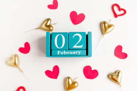 February 2. Blue cube calendar with month and date and decorative hearts on white background.の写真素材