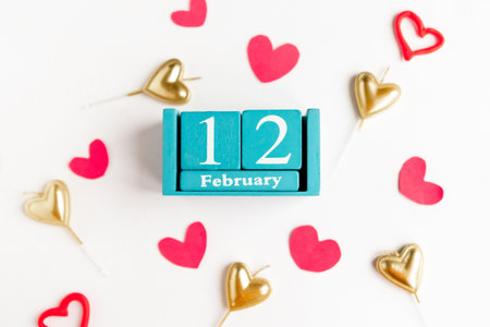 February 12. Blue cube calendar with month and date and decorative hearts on white background.の写真素材
