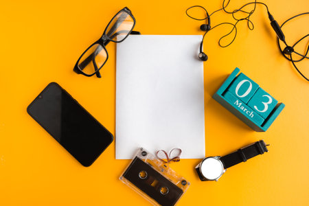 March 3. Blue cube calendar with month and date and white mockup blank on orange background.の写真素材