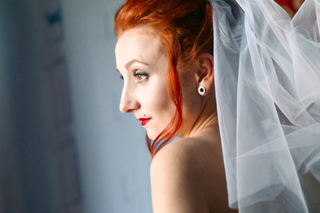 Portrait of young bride in wedding dress and veil, close upの写真素材