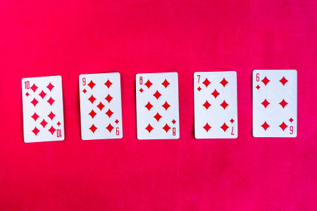 Poker straight flush playing card, top view, red backgroundの写真素材