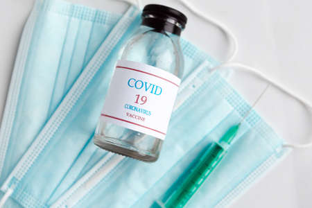 Coronavirus vaccine bottle, face mask and syringe injection. Prevention and treatment from corona virus infection. Medicine infectious concept.の写真素材