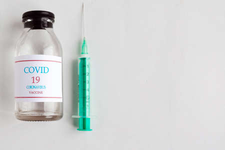 Coronavirus vaccine bottle and syringe injection. Prevention and treatment from corona virus infection. Medicine infectious concept. Copy spaceの写真素材