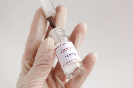 Development and creation of a coronavirus vaccine COVID-19. Coronavirus Vaccine concept in hand of doctor. Prevention of coronavirus pandemic concept.の写真素材