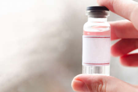 Development and creation of a coronavirus vaccine COVID-19. Coronavirus Vaccine concept in hand of doctor. Prevention of coronavirus pandemic concept.の写真素材