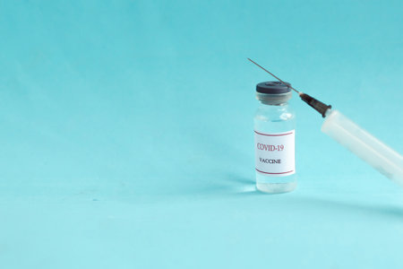 Coronavirus vaccine bottles and syringe injection. Prevention and treatment from corona virus infection. Medicine infectious concept.の写真素材