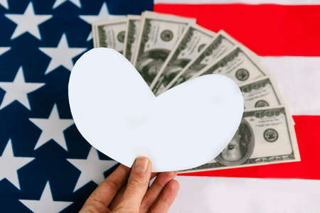 American flag, white mockup heart and dollars. Love money conceptの写真素材