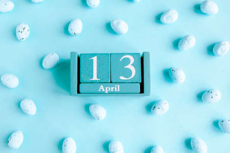 April 13. Blue cube calendar with month and date on blue background.の写真素材