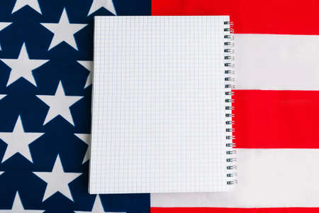 White mockup notebook on American flag background. Template for designerの写真素材