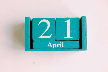 April 21. Blue cube calendar with month date isolated on white background.の写真素材
