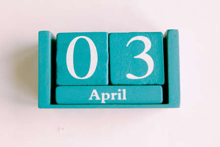 April 3. Blue cube calendar with month date isolated on white background.の写真素材