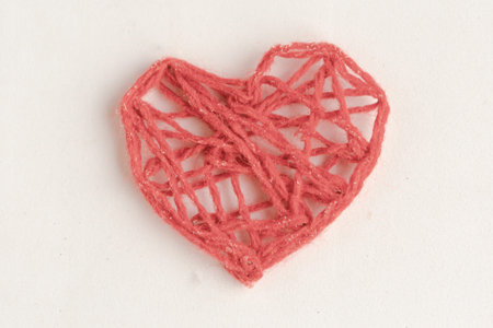 Red knitted handmade heart isolated on white background. Happy Valentine's Day.