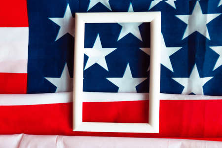 White photo frame on American flag background. Template for designer. Copy space for the textの写真素材