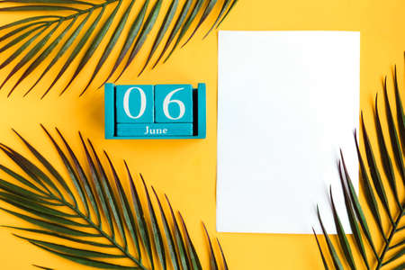 June 6. Blue cube calendar with month date on yellow background.の写真素材