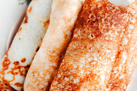 Close up photo of tasty homemade pancake rolls on wooden background, top view. Carnival Russiaの写真素材