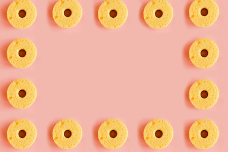 Seamless pattern of yellow sponges for washing dishes on pink background. minimal concept. Copy...
