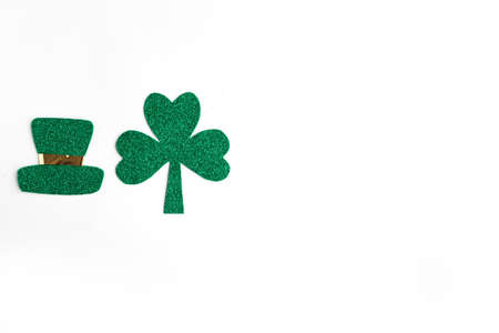 Happy St. Patrick's Day. Green hat and three leaf clover isolated on white background. Patrick Day symbols on Ireland flag background. Copy space for the textの写真素材