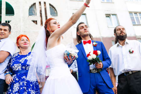 Minsk Belarus â August 7 2020: Bride leaves her father's house and treats the children with sweets. Russian national traditionのeditorial素材